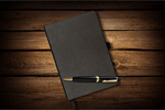 Сlipart Notebook and pen on table moleskin notebook black leather   BillionPhotos